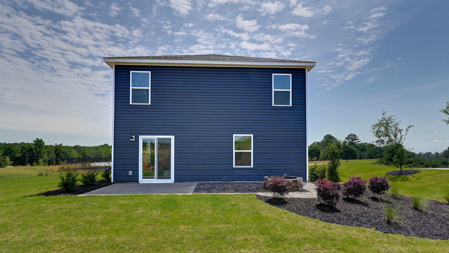 Back exterior of the Robie in Ferry Grove with a paved back patio