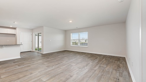 The dining area features ample natural light from back sliding glass doors.