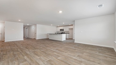 The dining, living, kitchen areas are open concept design finished with Revwood flooring.
