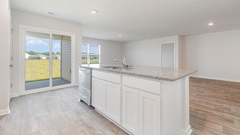 The dining, living, kitchen areas are open concept design finished with Revwood flooring.