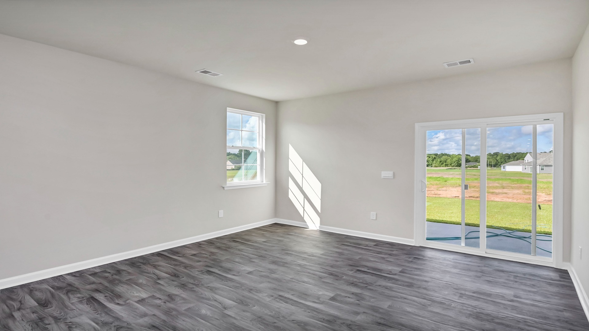 Access to back patio in living area through glass sliding doors