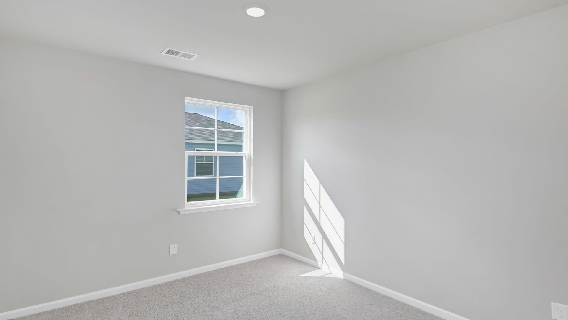 Bedroom 2 with carpet flooring and a window for light