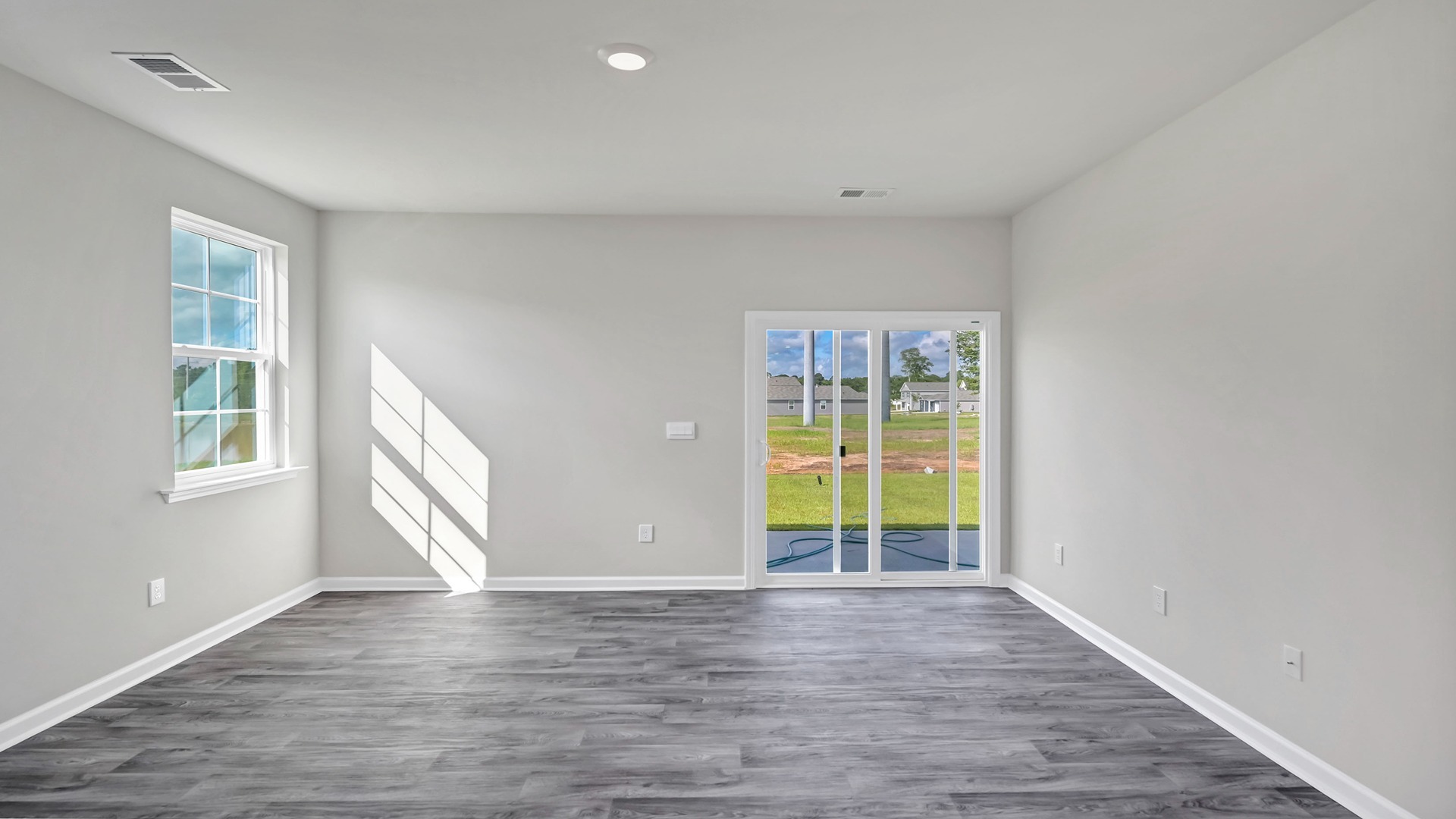 Access to the paved back patio through glass sliding doors in the living room