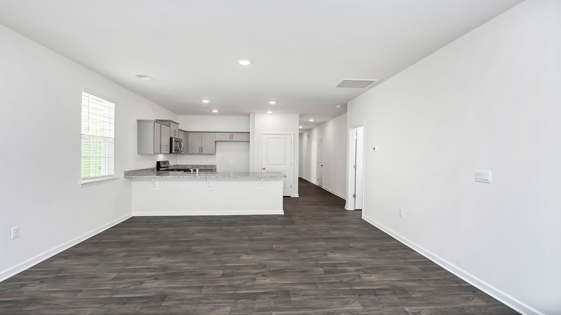 The dining, living, kitchen areas are open concept design finished with Revwood flooring.