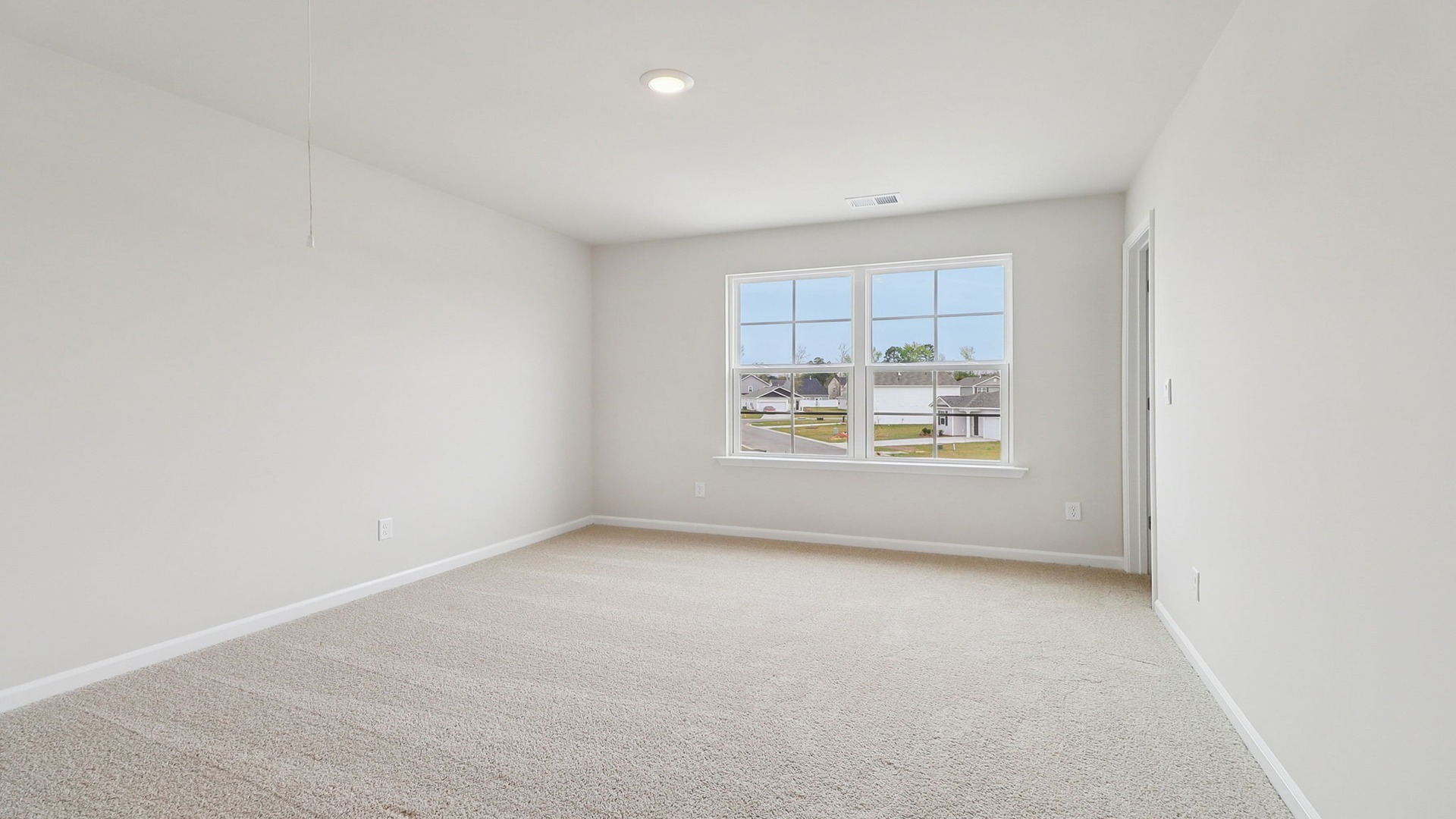 Bedroom 2 upstairs with carpet flooring and a large front facing window