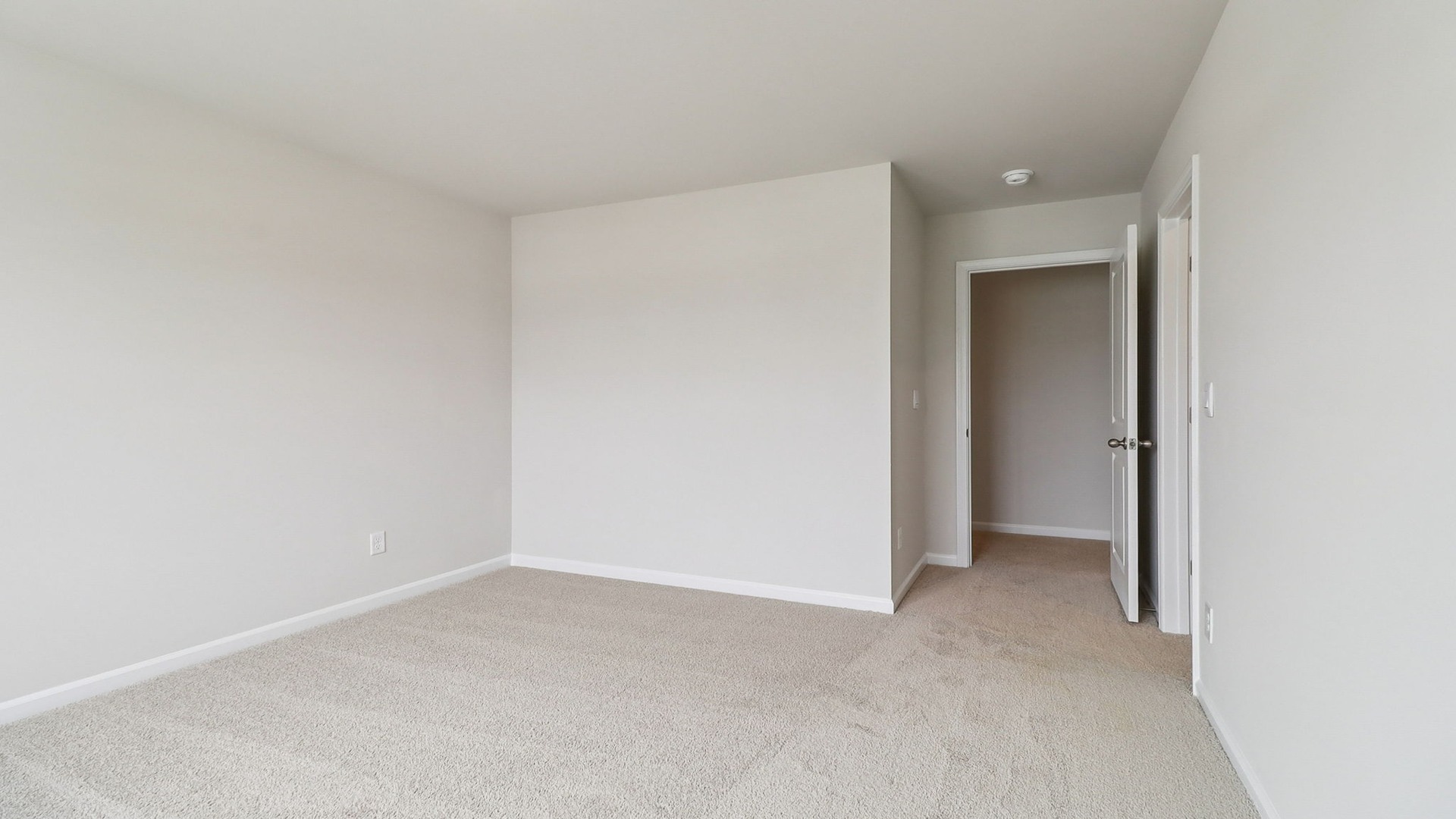 Carpet flooring and neutral painted walls in bedroom 3