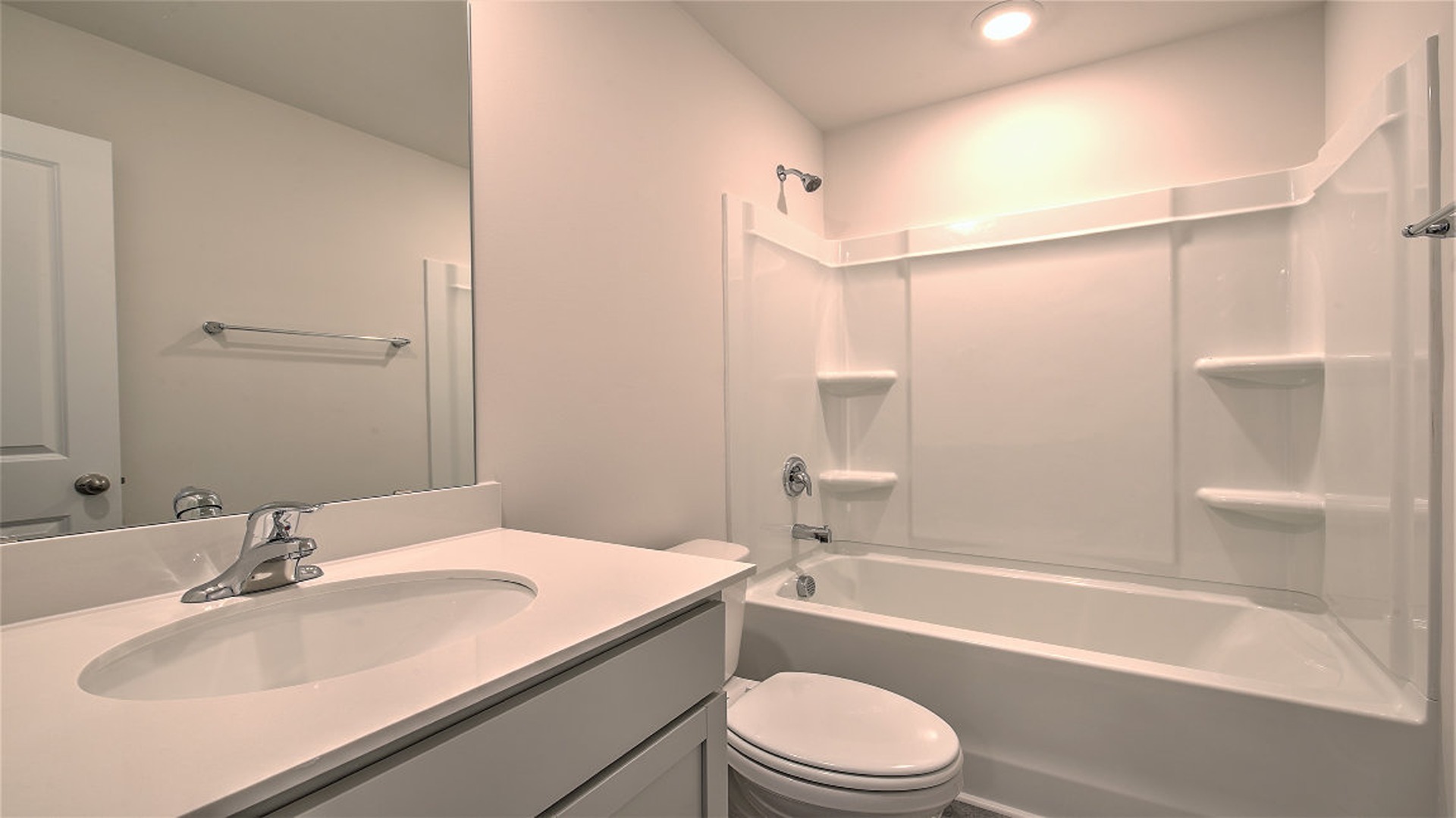 Bathroom 2 upstairs with gray cabinetry and shower/tub combo