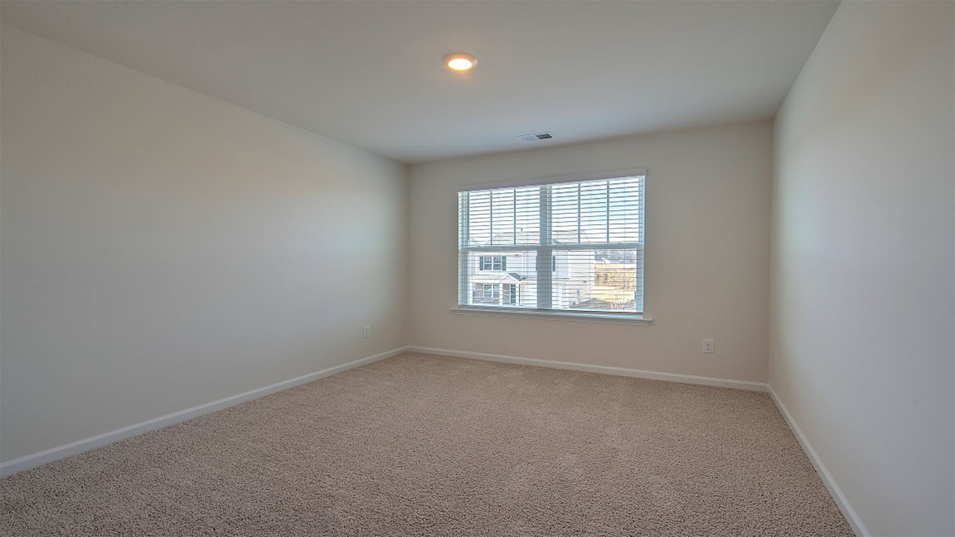 Bedroom 3 upstairs with carpet flooring and a large window for light