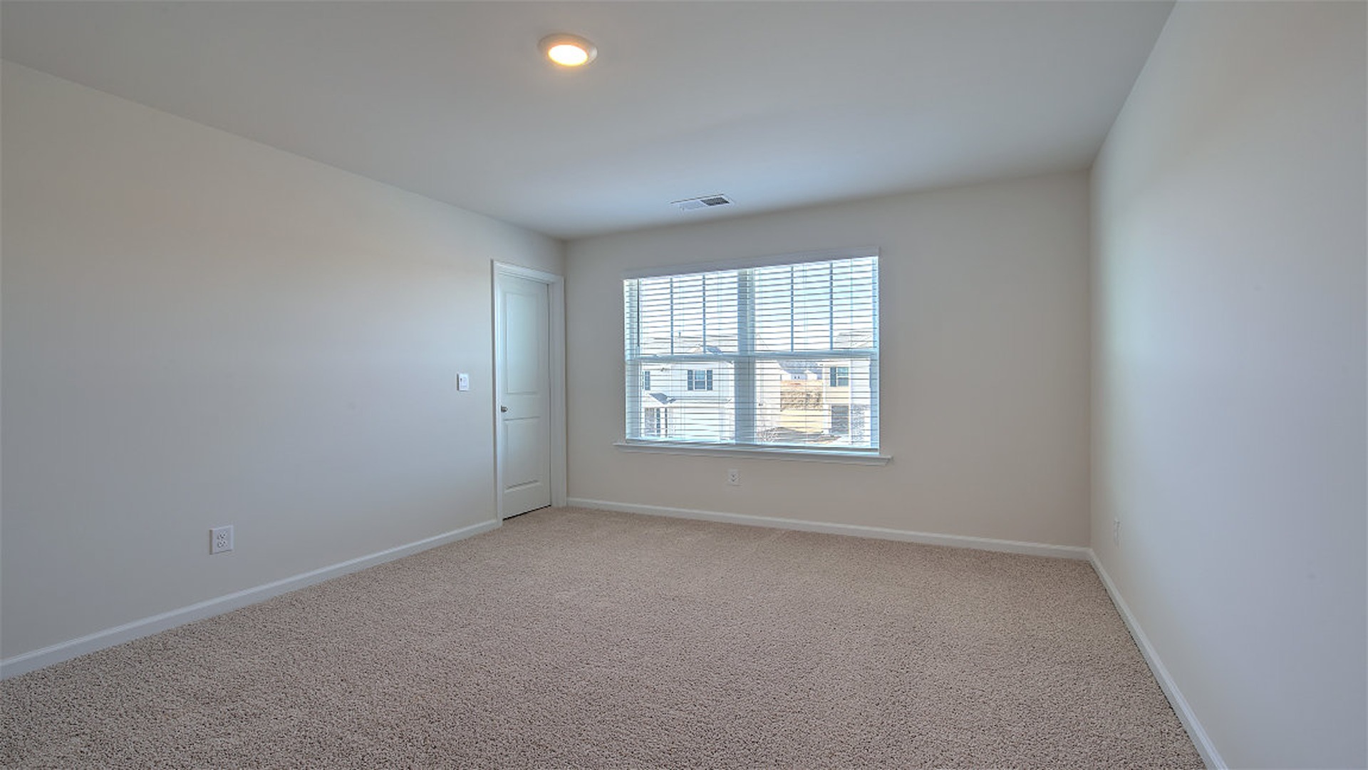 Bedroom 2 upstairs with carpet flooring and a large window for light
