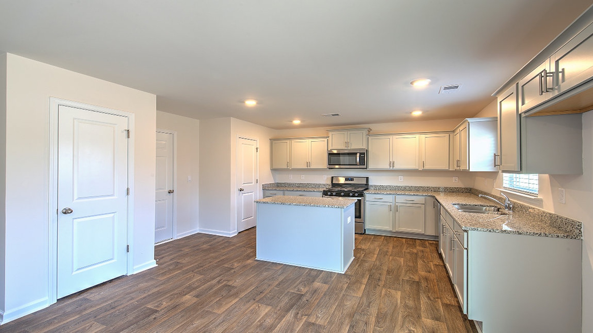 Living area leads into kitchen and dining spaces