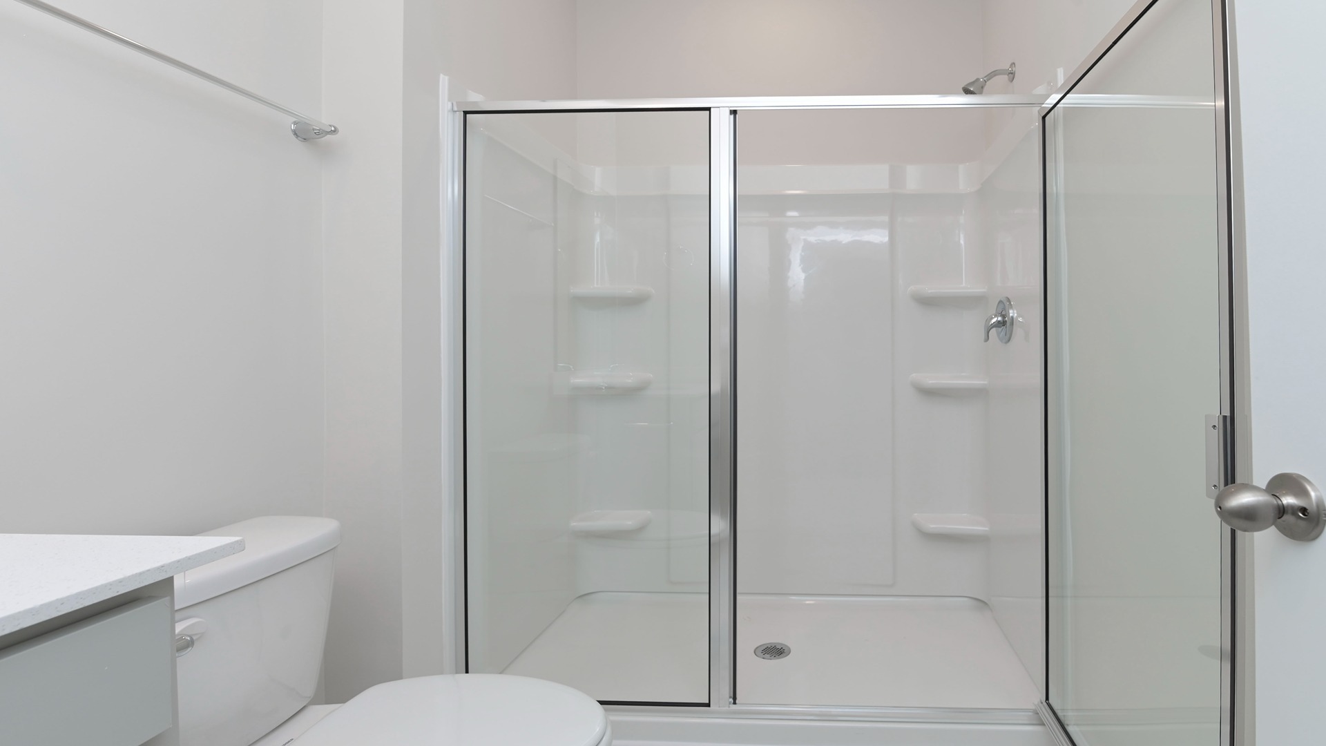 Walk-in shower in downstairs bathroom with glass doors