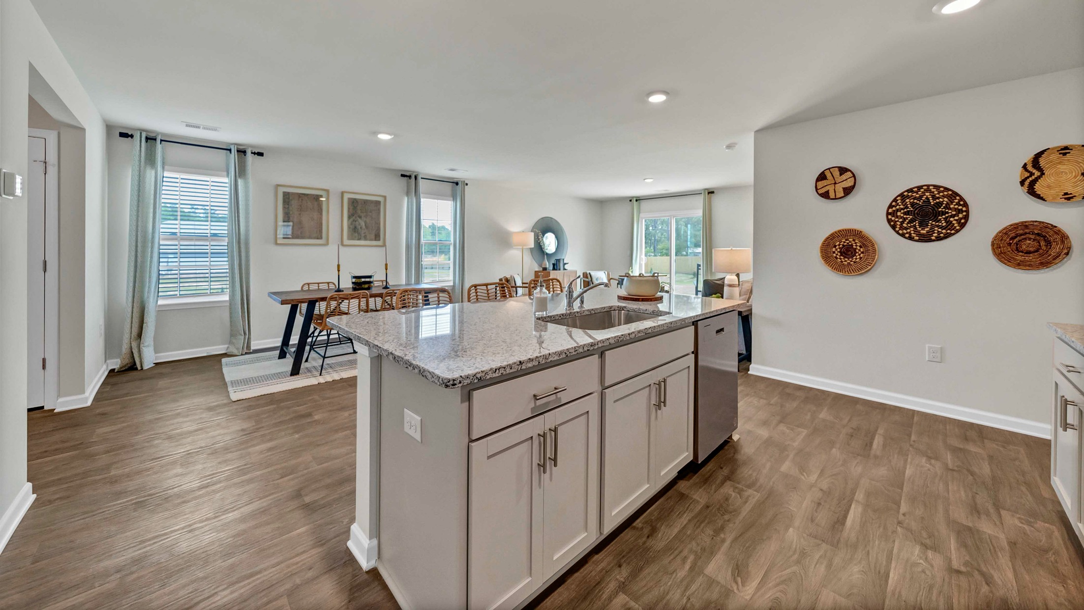 Floating kitchen island overlooks dining and living areas