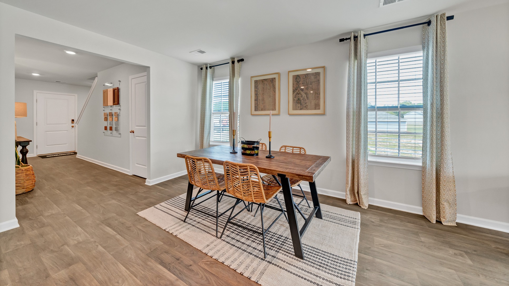 Open dining area with vinyl floors and windows for natural light