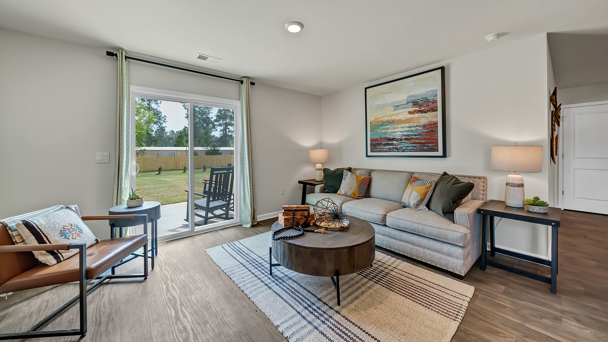 Back sliding doors in the living area lead out to the paved back patio and backyard