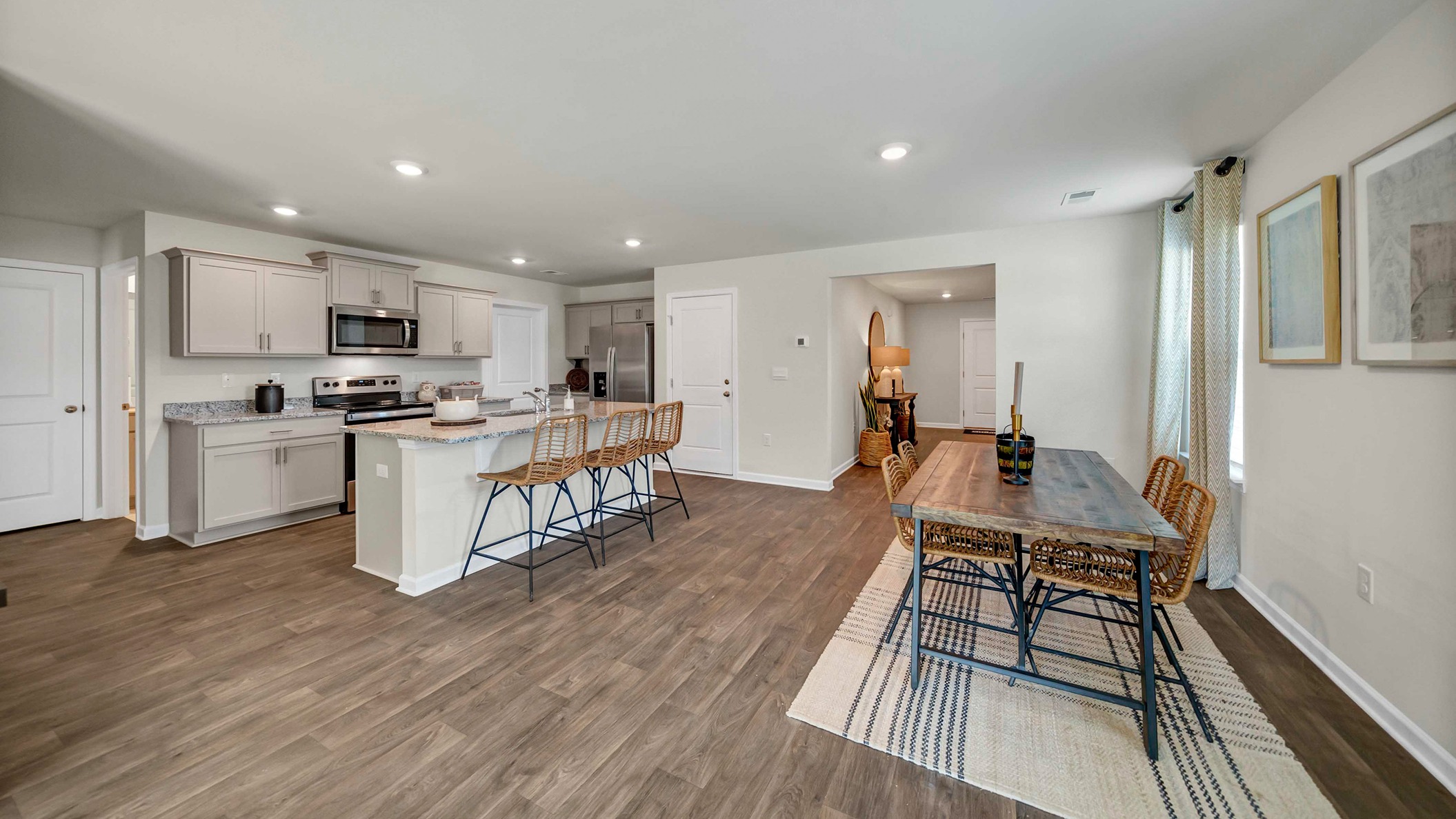 Kitchen and dining areas seamlessly flow together with matching vinyl floors
