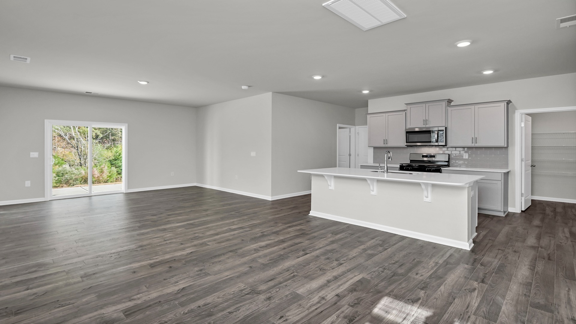 Open concept kitchen and living spaces with vinyl flooring