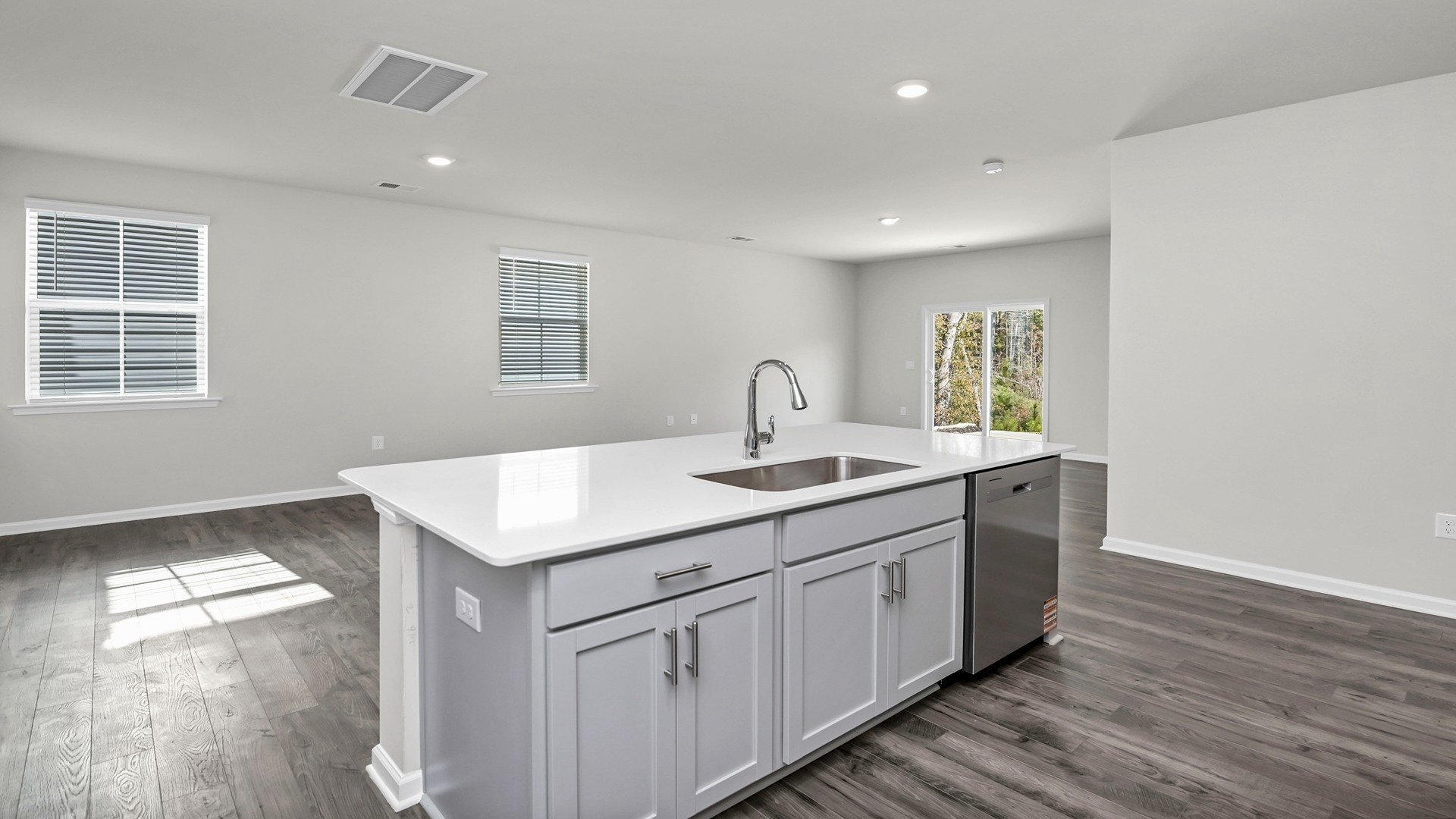 Floating island with sink and dishwasher overlooking dining and living areas