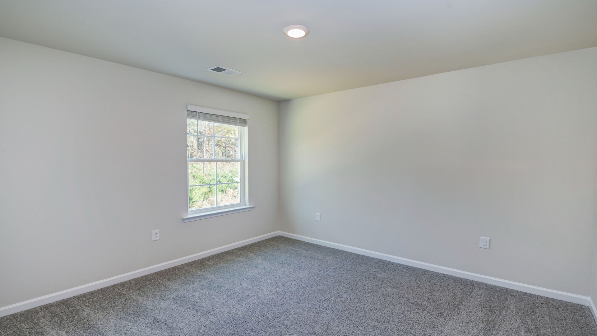Bedroom 4 upstairs with a window for light and carpet floors