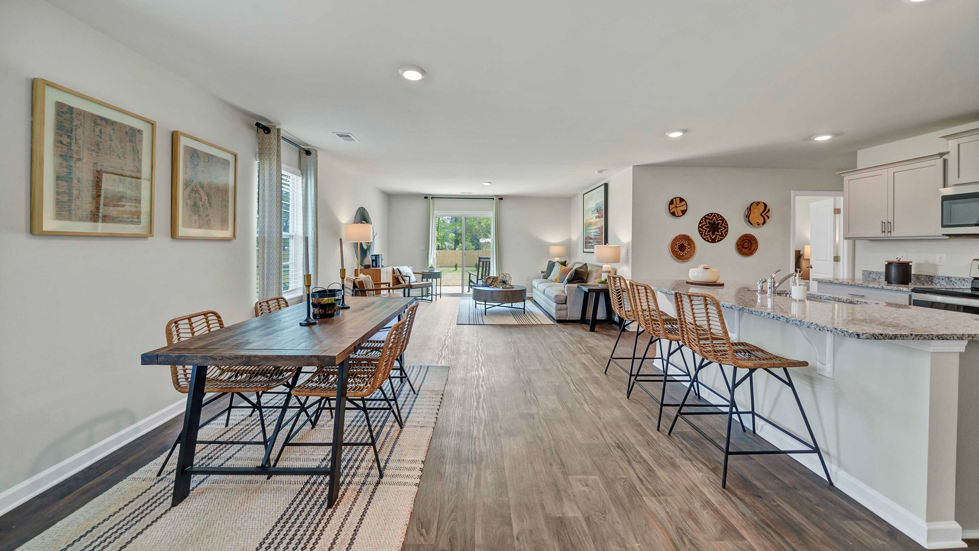 Open concept dining, living, and kitchen areas