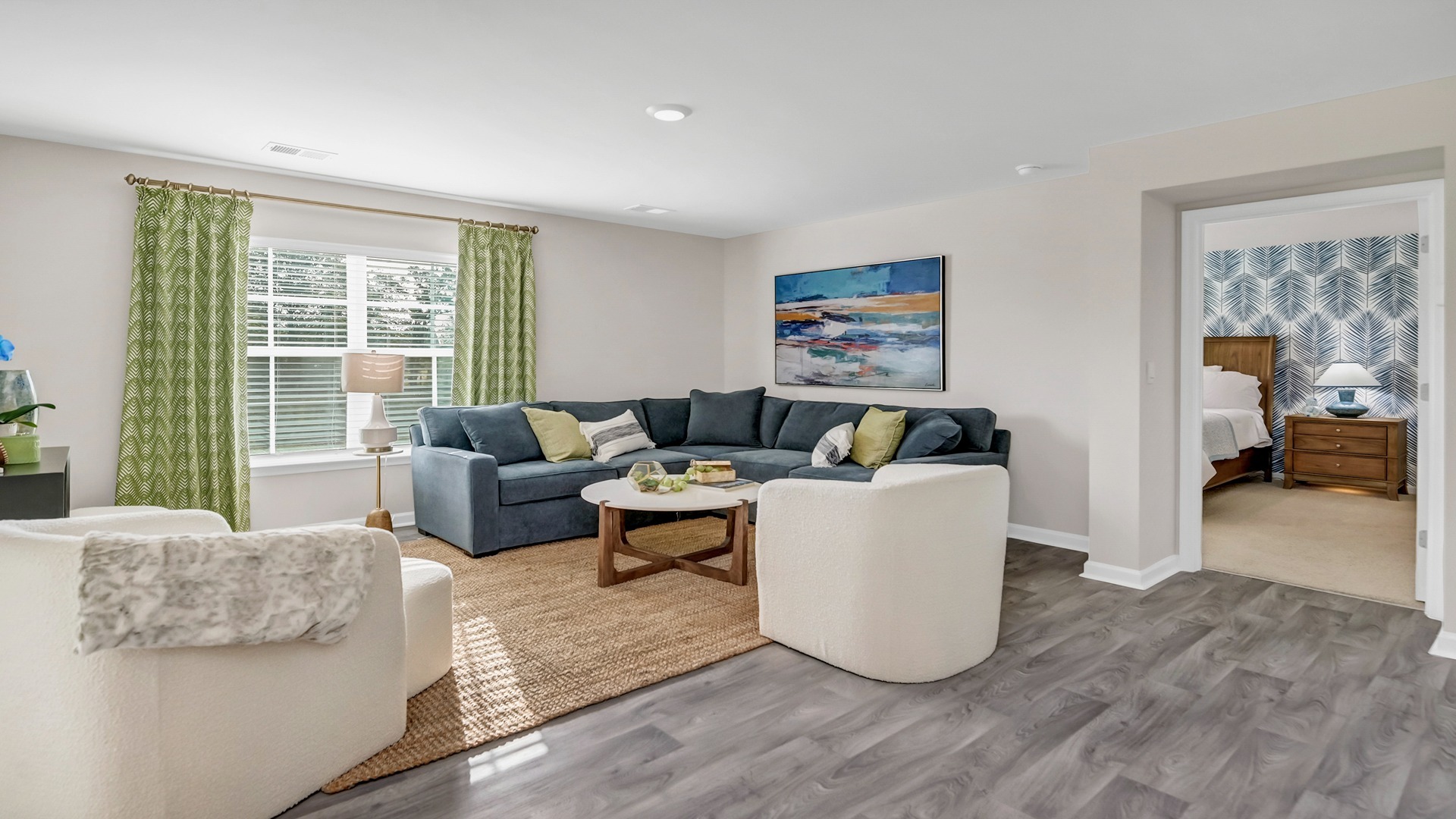 Furnished living area leads into primary bedroom