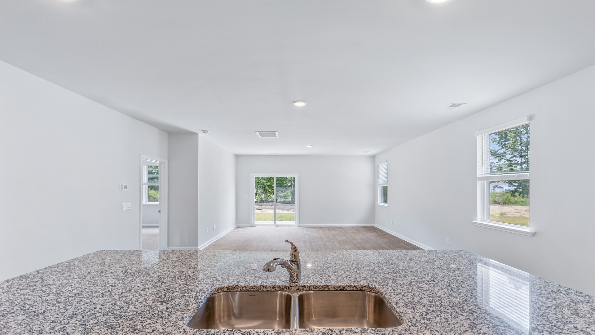 The kitchen sink overlooks the dining and living areas