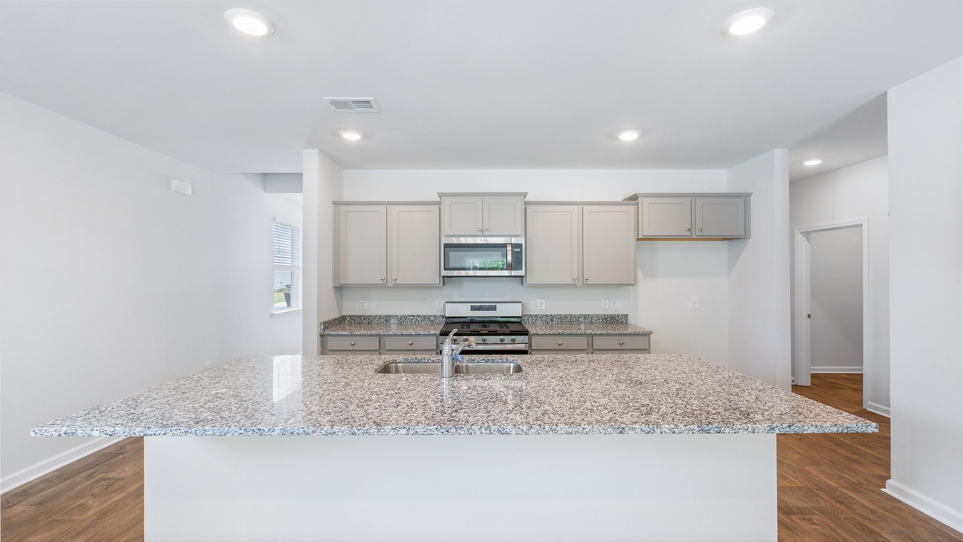 Manning kitchen with gray cabinetry and granite countertops