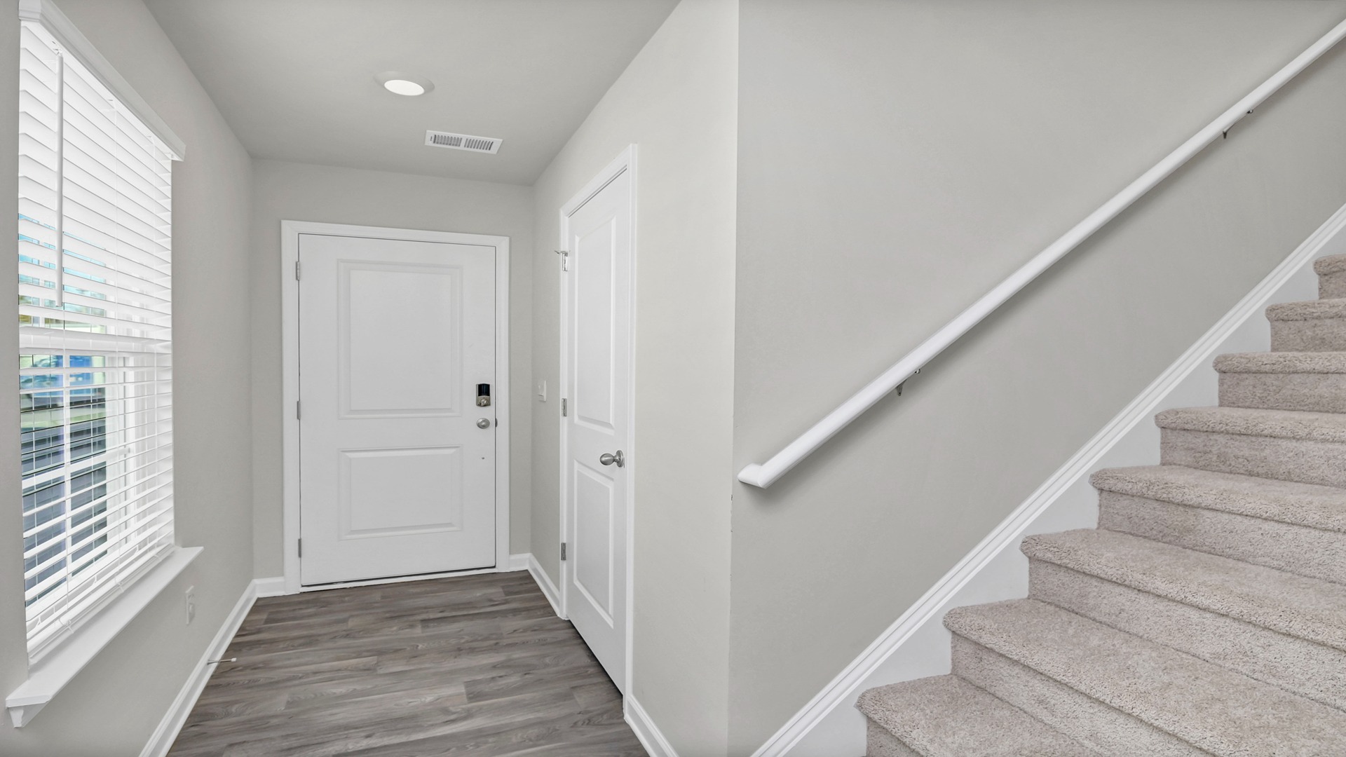 Stairway to upstairs in front foyer
