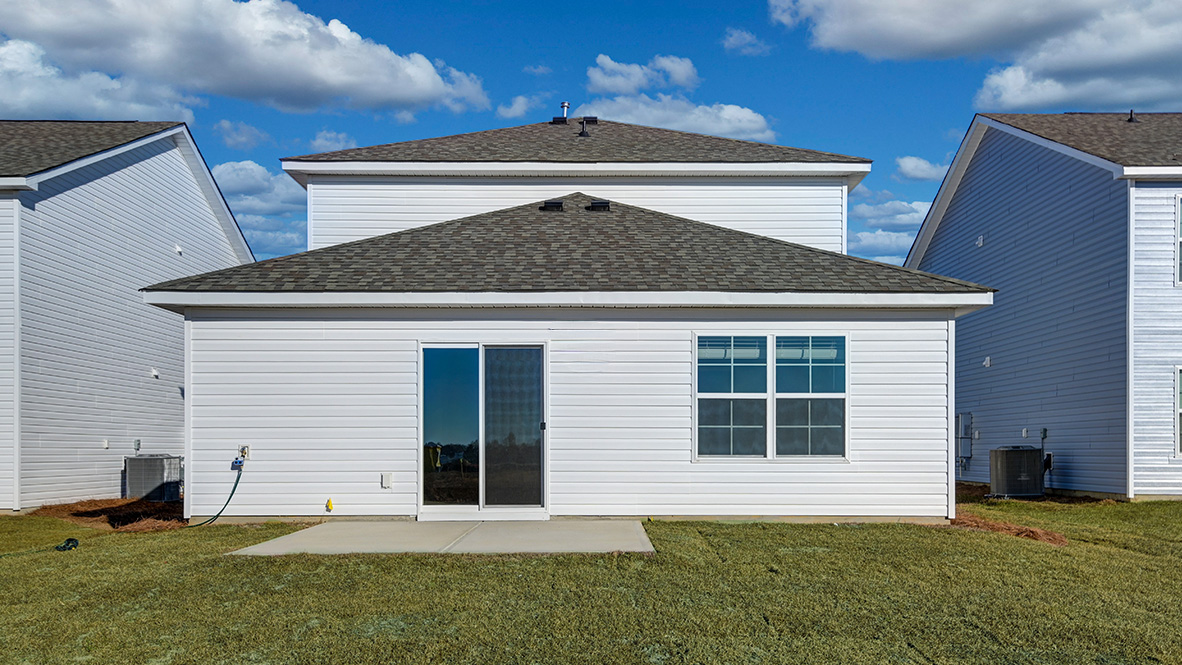 The back of the Manning features a paved patio and glass sliding doors