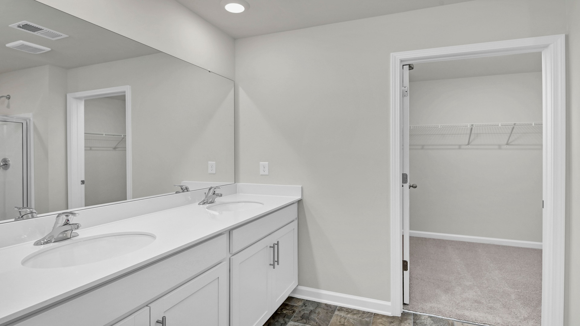 En-suite primary bathroom and walk-in closet