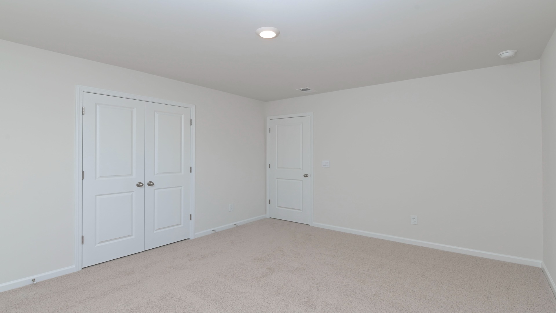 Bedroom 3 with French closet doors and plush carpet flooring