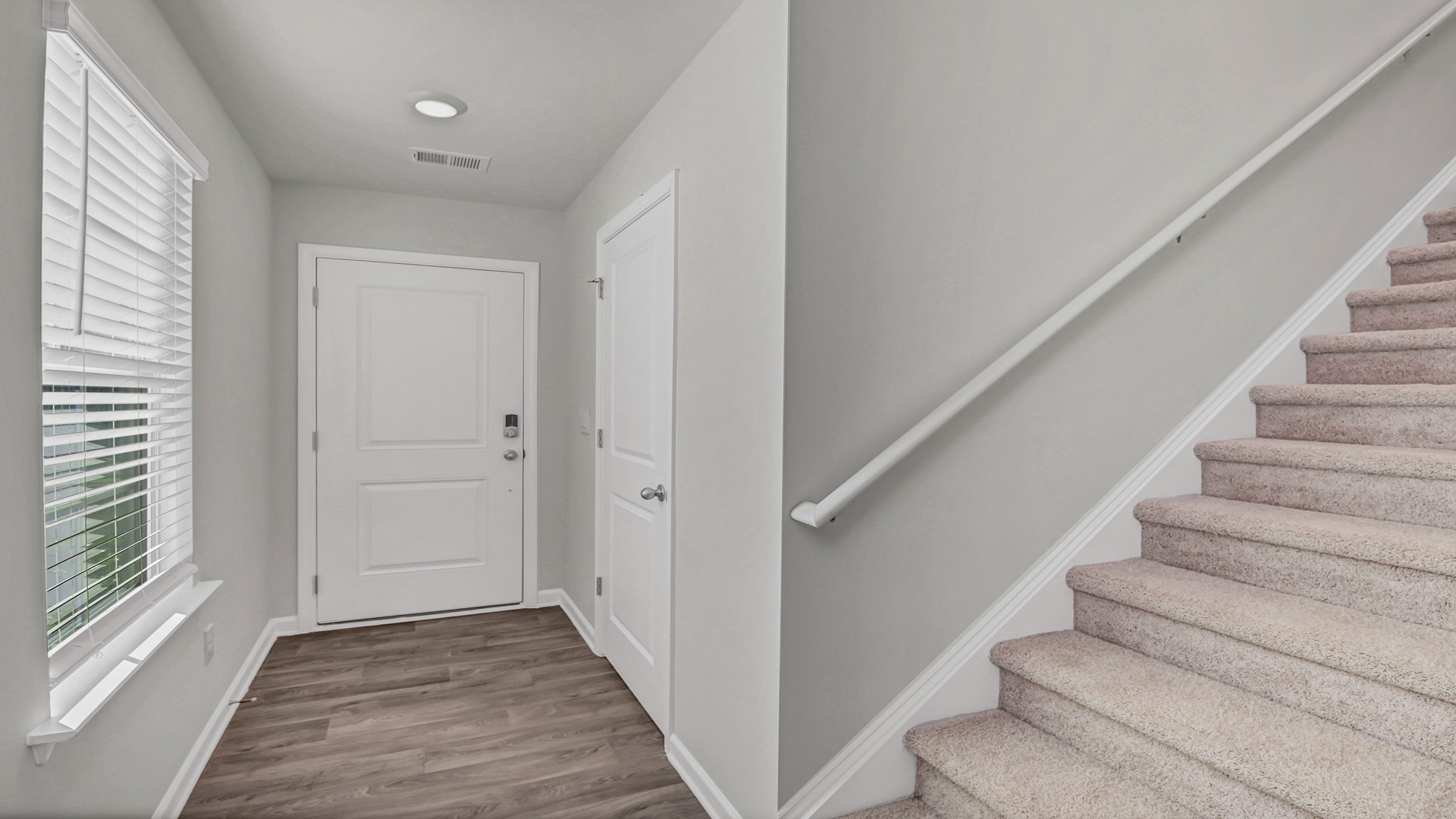 Carpeted stairway to upstairs at the front foyer of the Manning floor plan