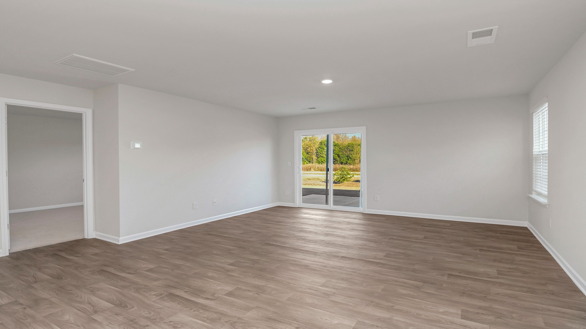 Access to primary suite from the dining and living areas on the first floor of new home