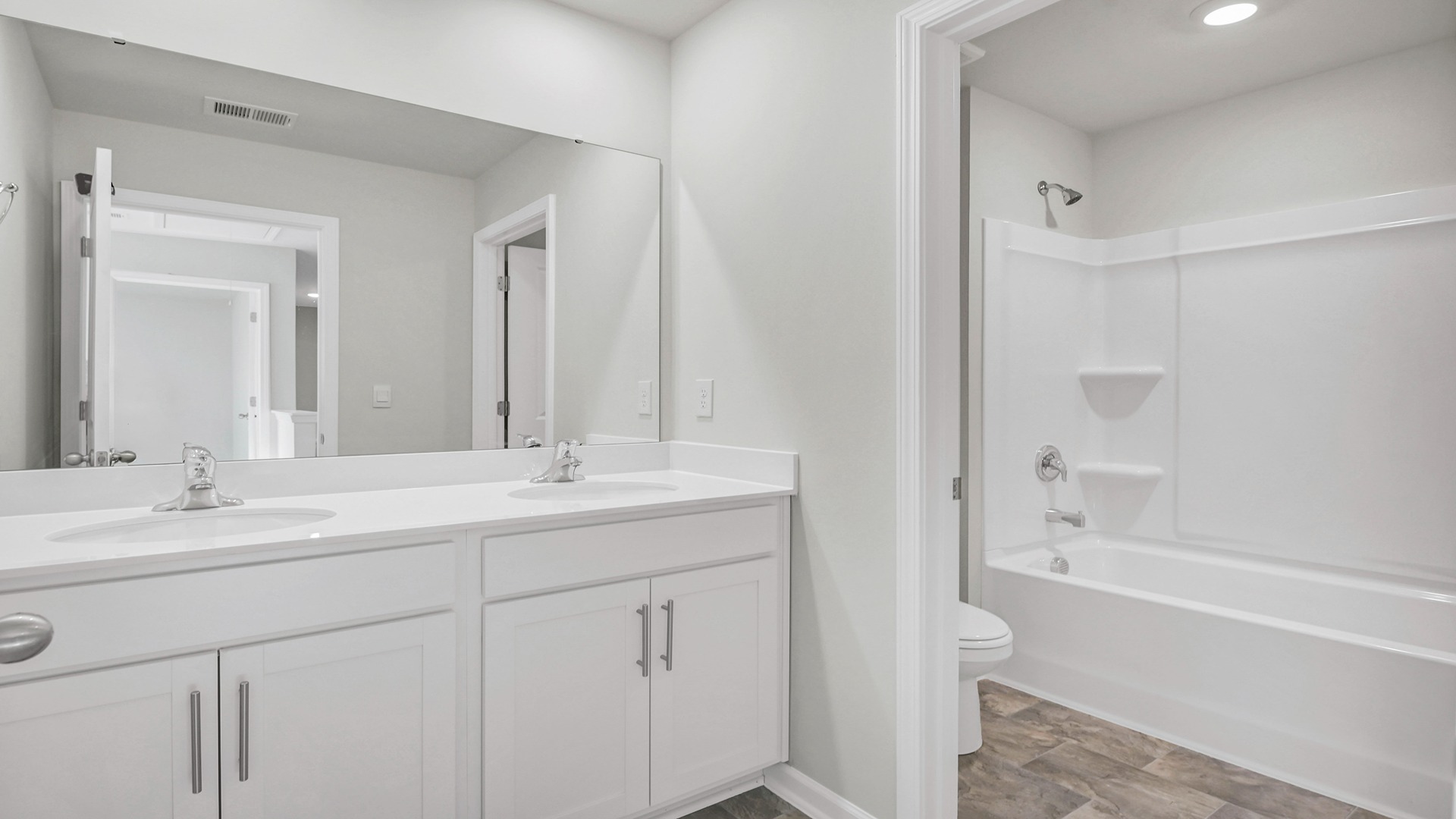 Bathroom 2 upstairs shared by upstairs bedrooms with a double vanity and shower tub combo