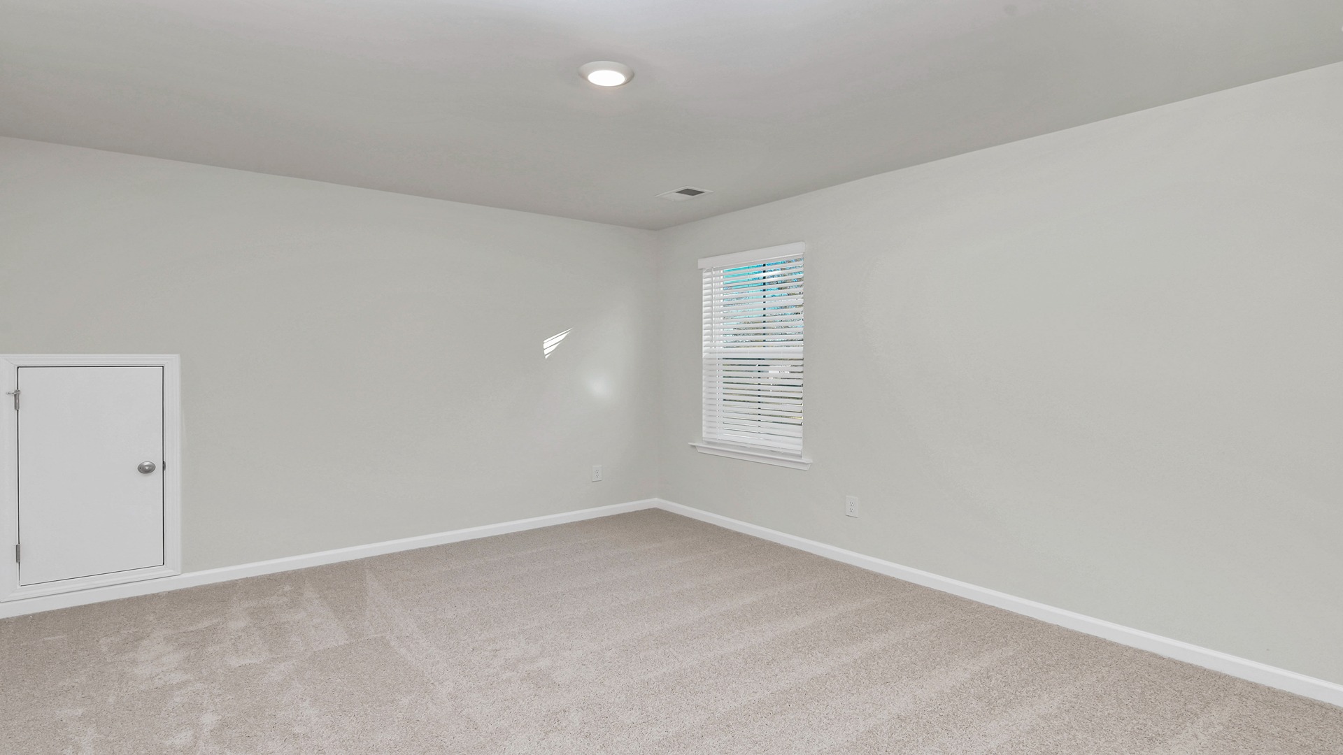 Bedroom 2 upstairs with a window for light and carpet flooring