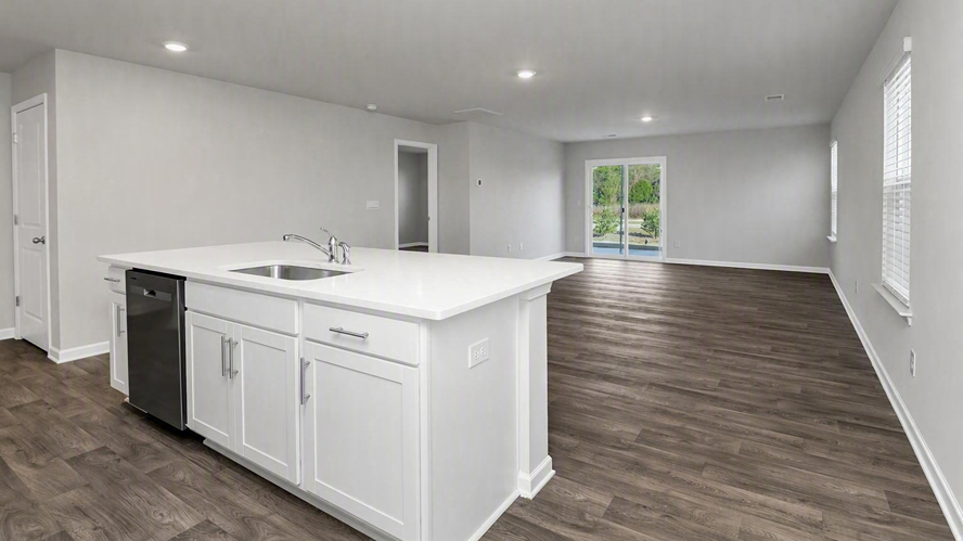 A floating kitchen island overlooks the completely open dining and living areas