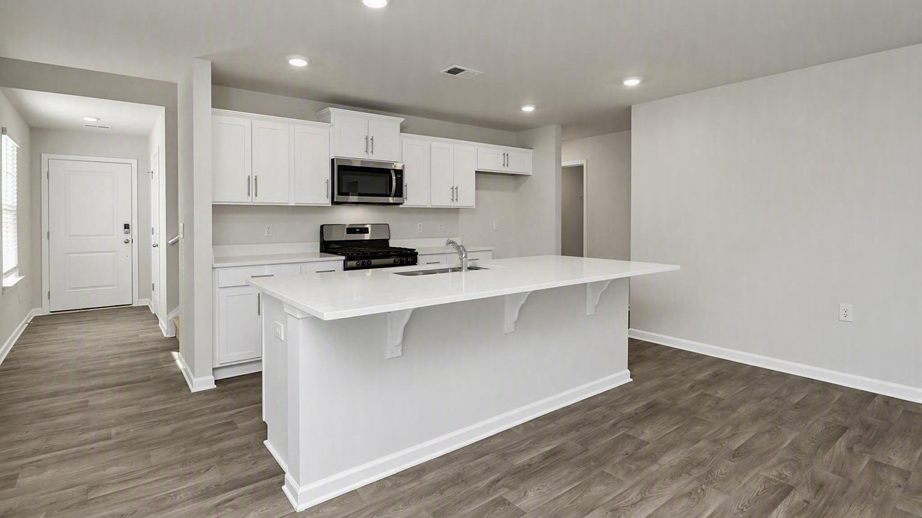 Front foyer of new construction home opens up into the open kitchen space