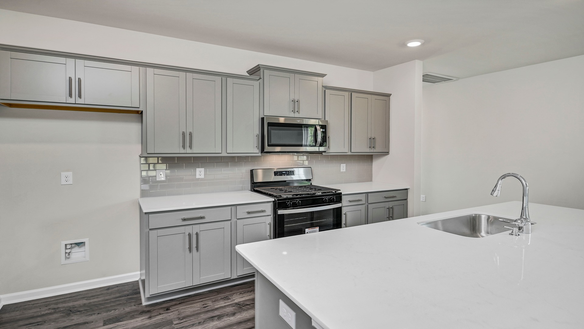 Gray cabinetry and quartz countertops in the Manning kitchen