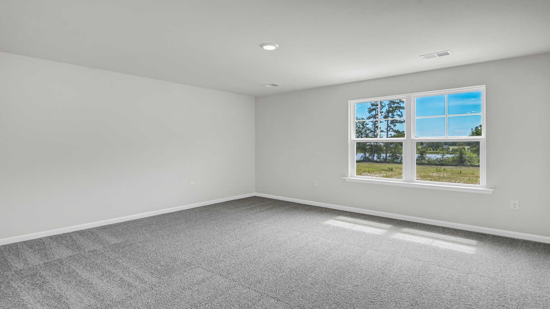 Upstairs living area with carpet flooring and a large window
