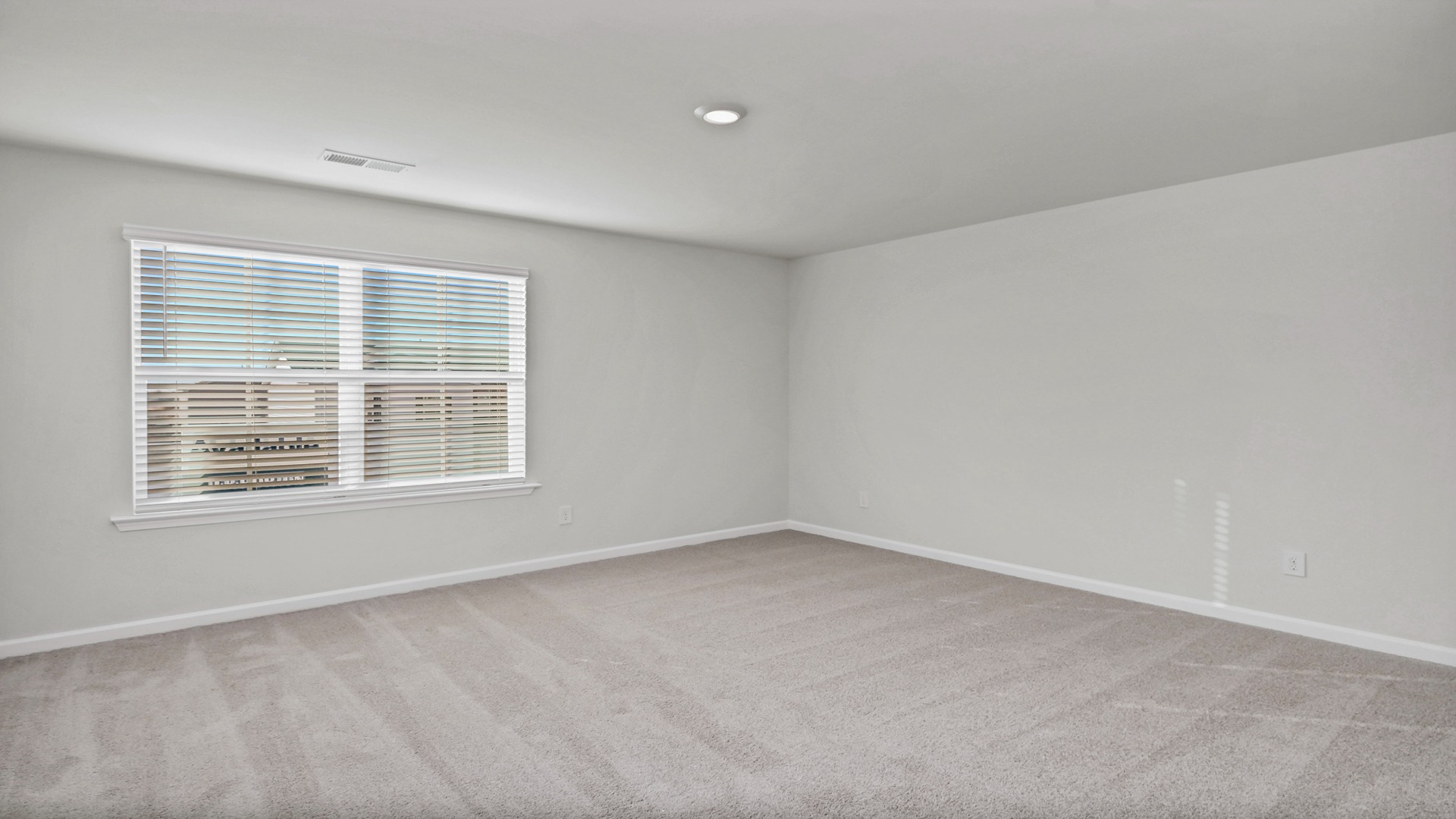 Upstairs loft/secondary living area with carpet flooring