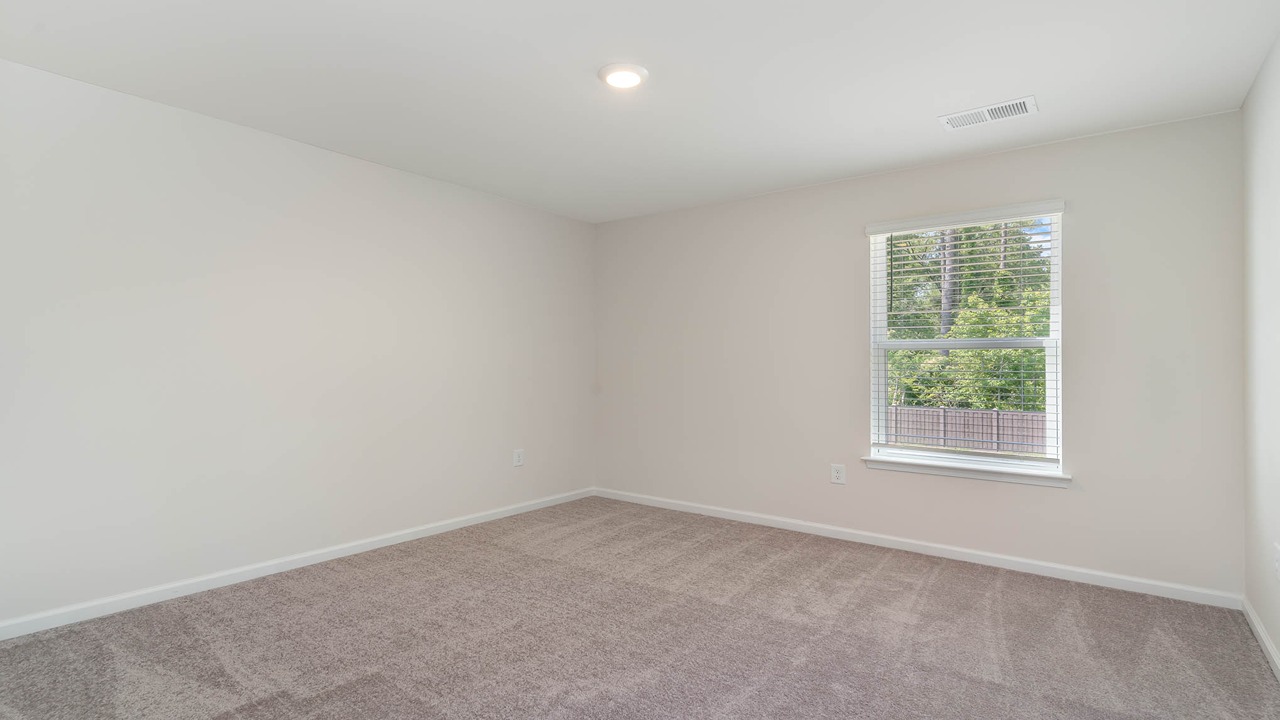 Bedroom 3 with carpet flooring and a window