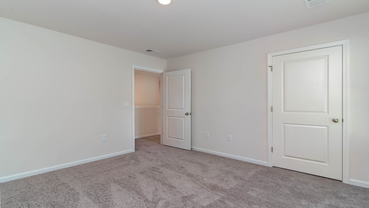 Bedroom 2 with carpet flooring and a window