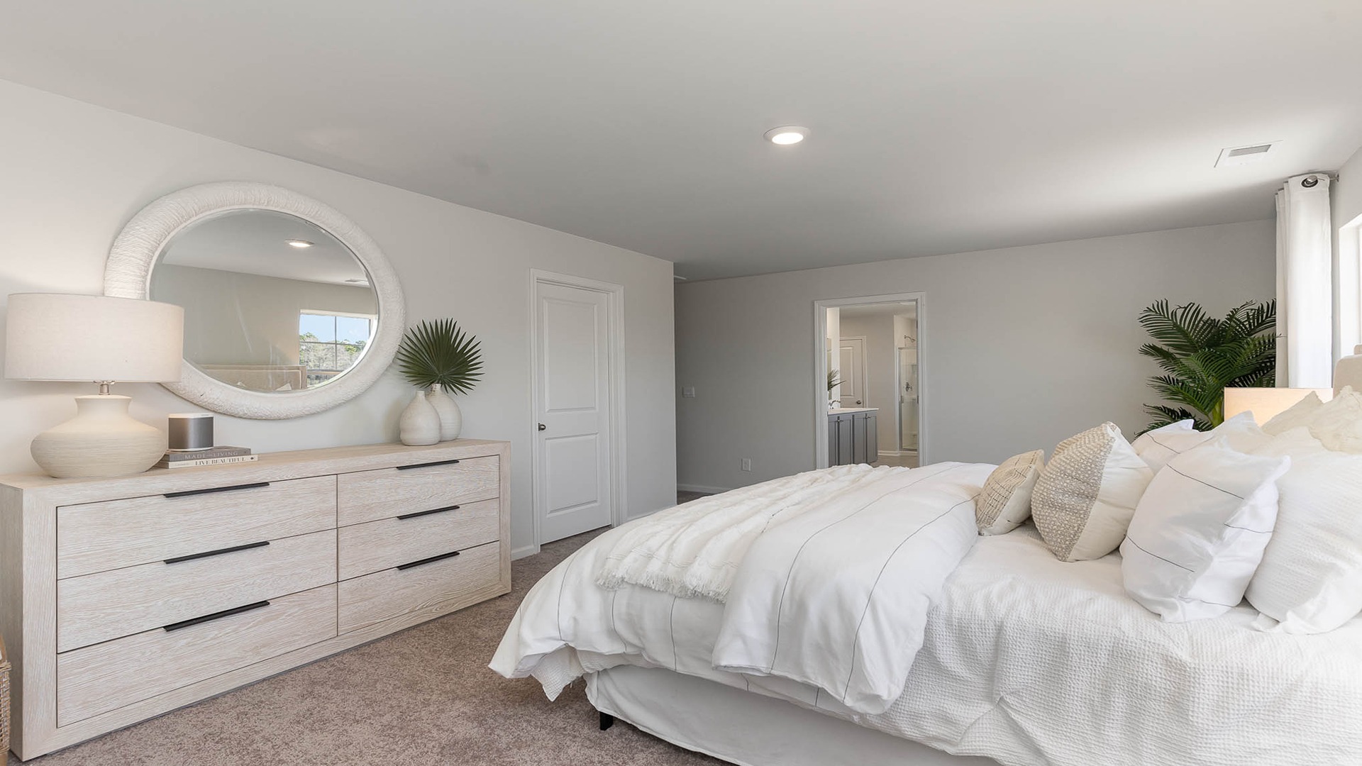 Spacious primary bedroom upstairs with carpet flooring