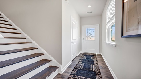 The stairway at the front of the home leads to the second story.