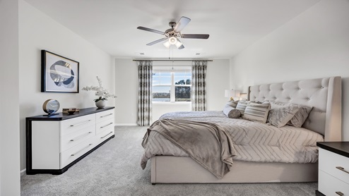 There is a large window in the primary bedroom for natural lighting.