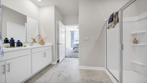 The Primary Bathroom at Sease's Pond features double sinks and a standup shower.