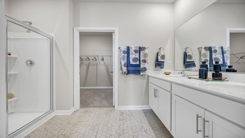 The primary bathroom also features a walk-in closet and standup shower.