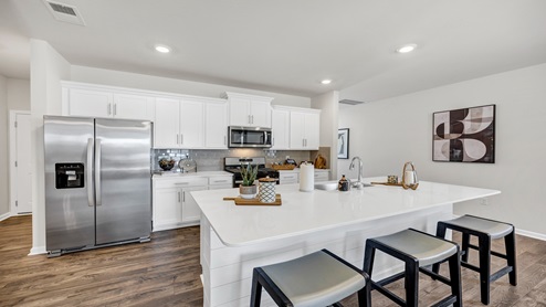 This Manning Kitchen features white cabinetry and sleek quartz countertops.