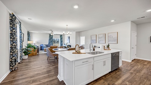 There is a floating kitchen island that overlooks the dining and living spaces.