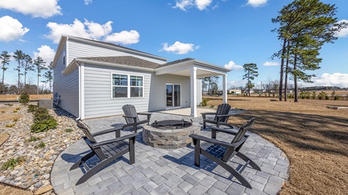 The back patio has been extended and features a firepit area.