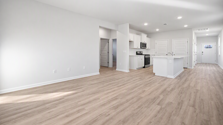 Open concept main living and kitchen areas with matching RevWood floors and neutral painted walls